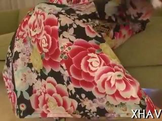Beautiful oriental sits on big dildo